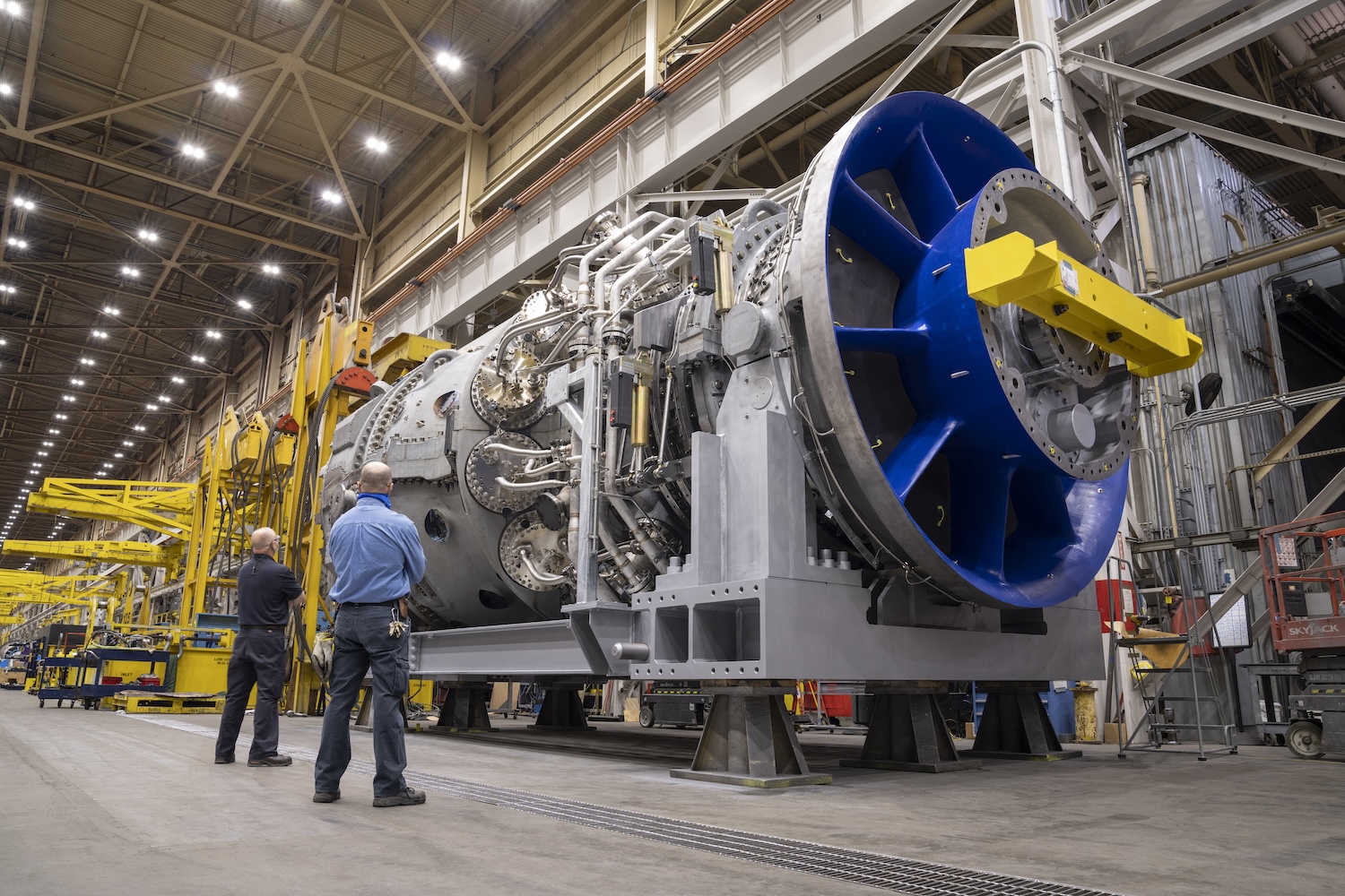 Two people standing in front of an engine