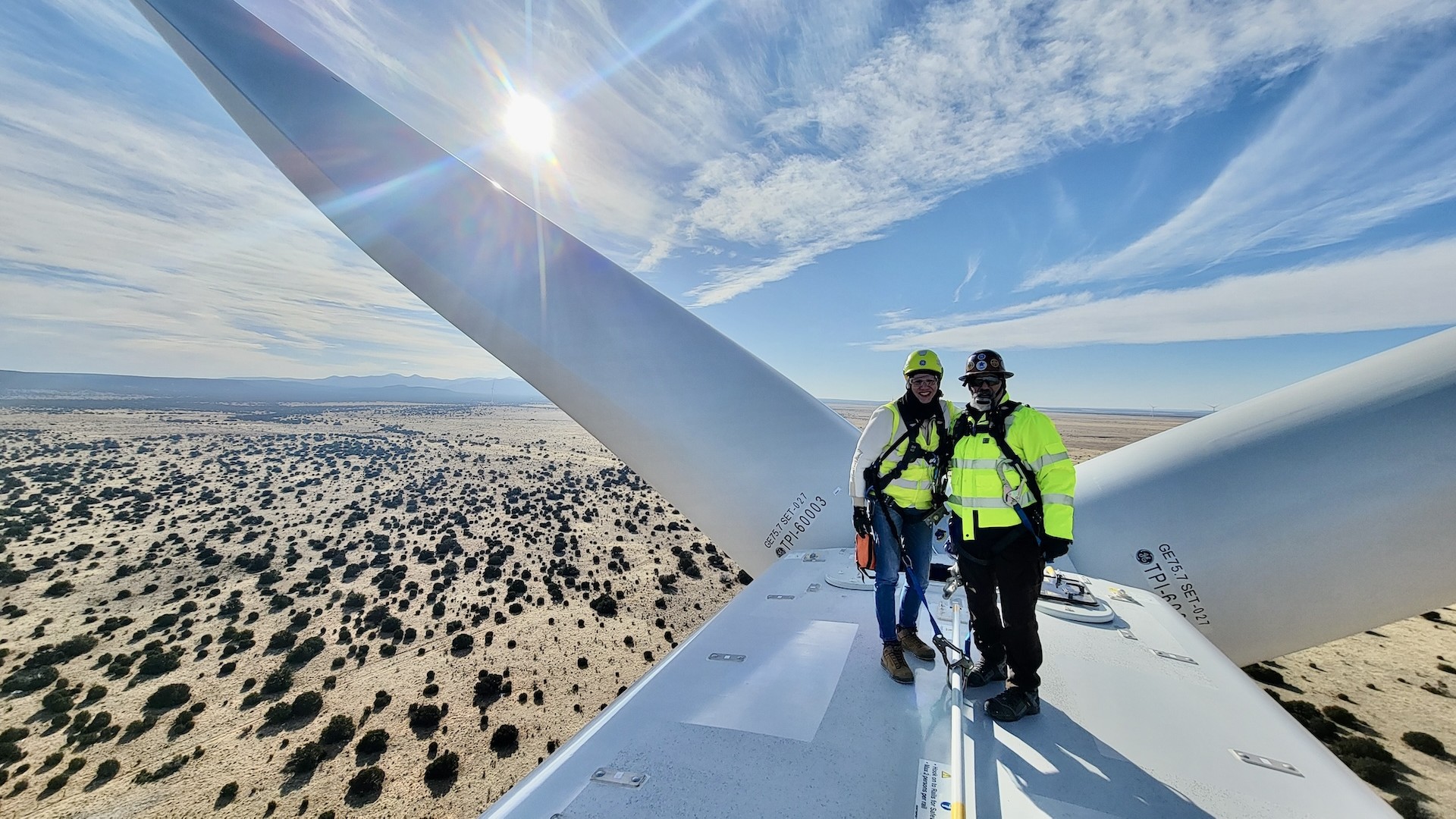 Two people standing on a windmill