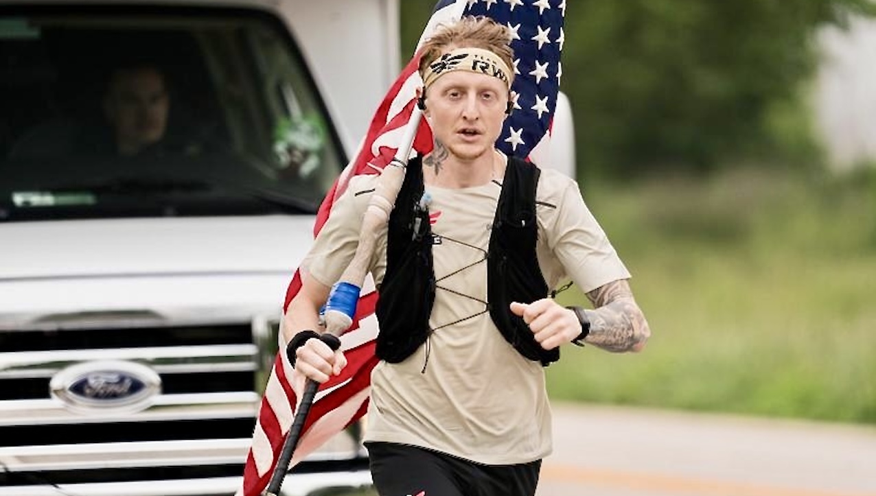 Man running with American flag in the background