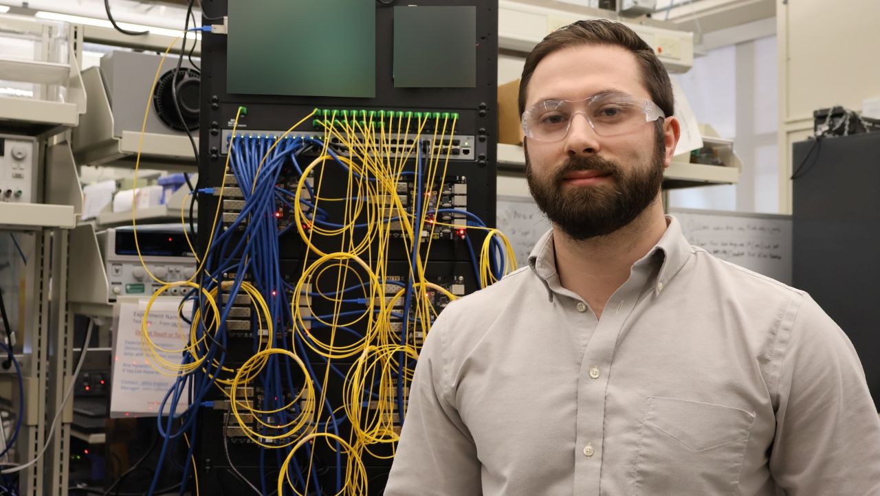 Mike Englert standing in front of board of wires