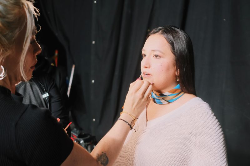 Woman getting lip gloss put on