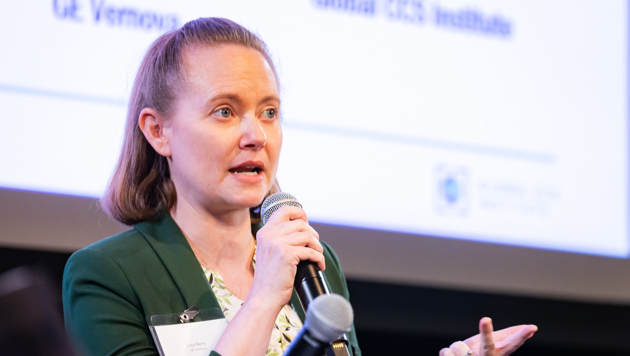 Berry speaking into a microphone onstage