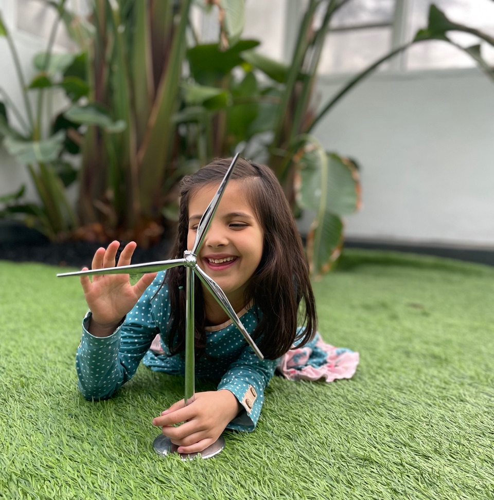 Barner's daughter Abigail playing with a toy windmill.