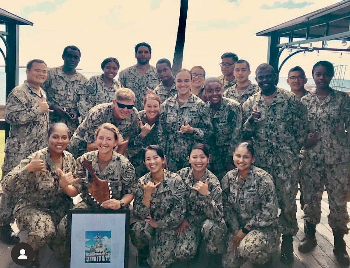 Group of military smiling in their uniforms outside