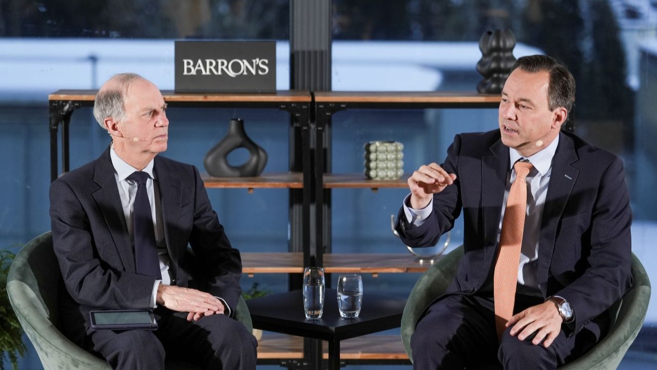 Two men speaking onstage