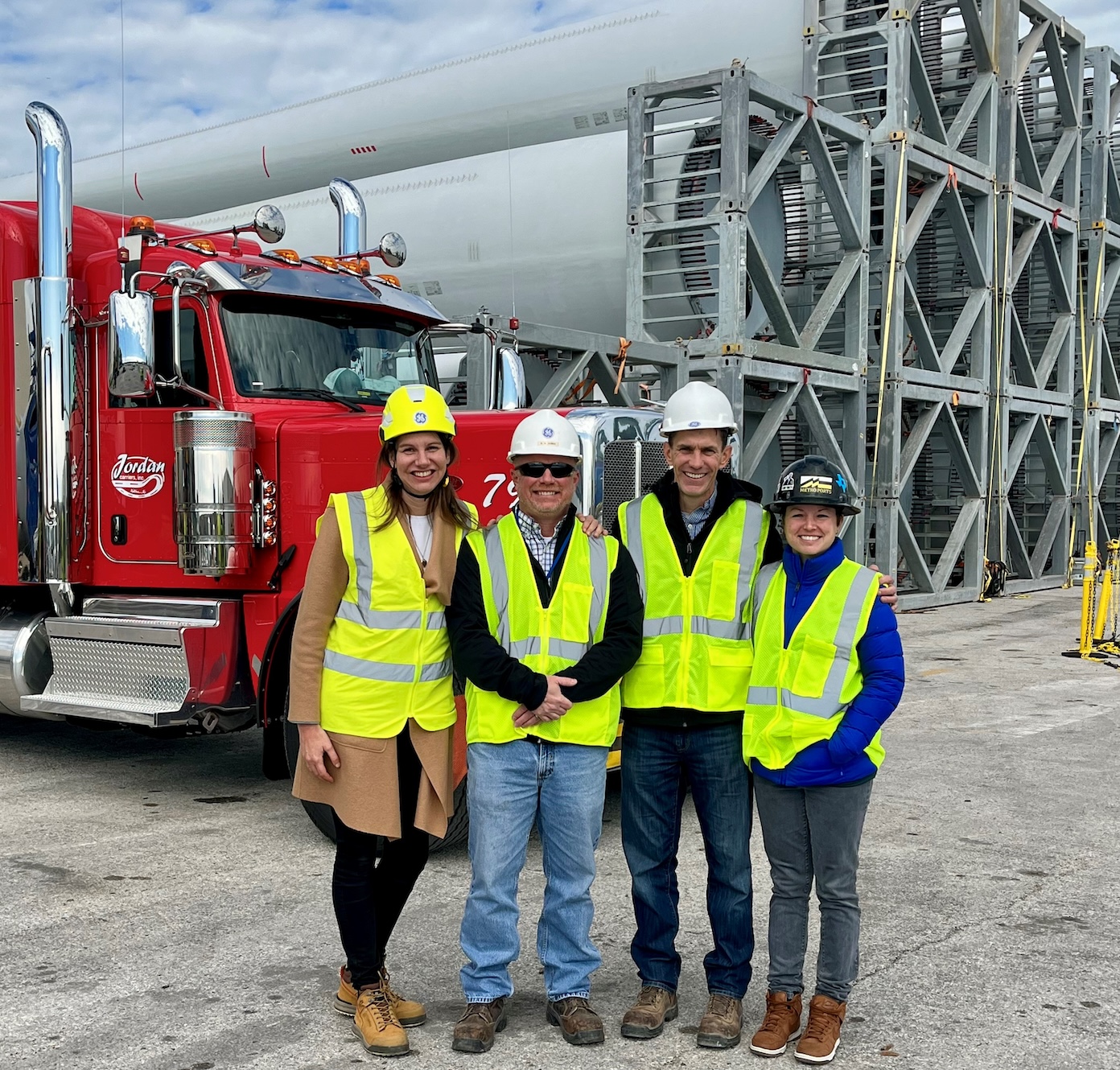 4 people in neon yellow work vests standing outside