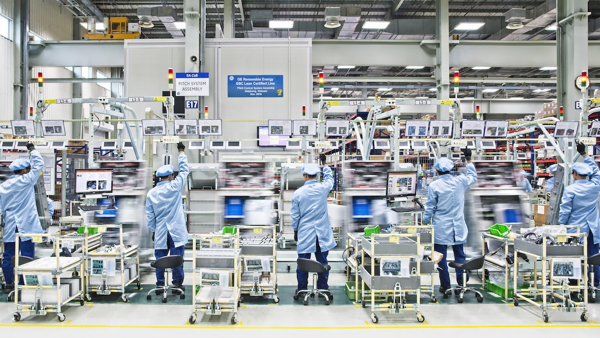 People in light blue on a production line