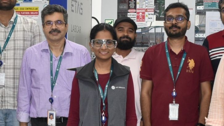 3 engineers standing in a group