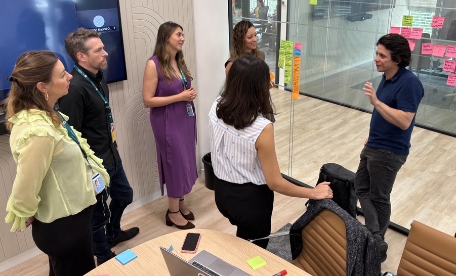 A group of people standing in a conference room