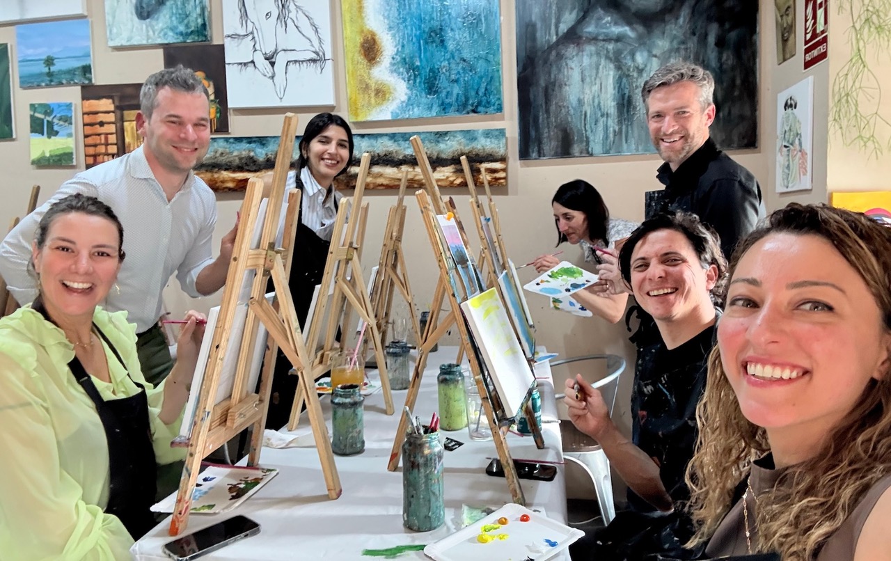 Group of people painting on small easles