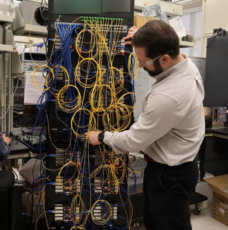 Man working with a huge structure of wires