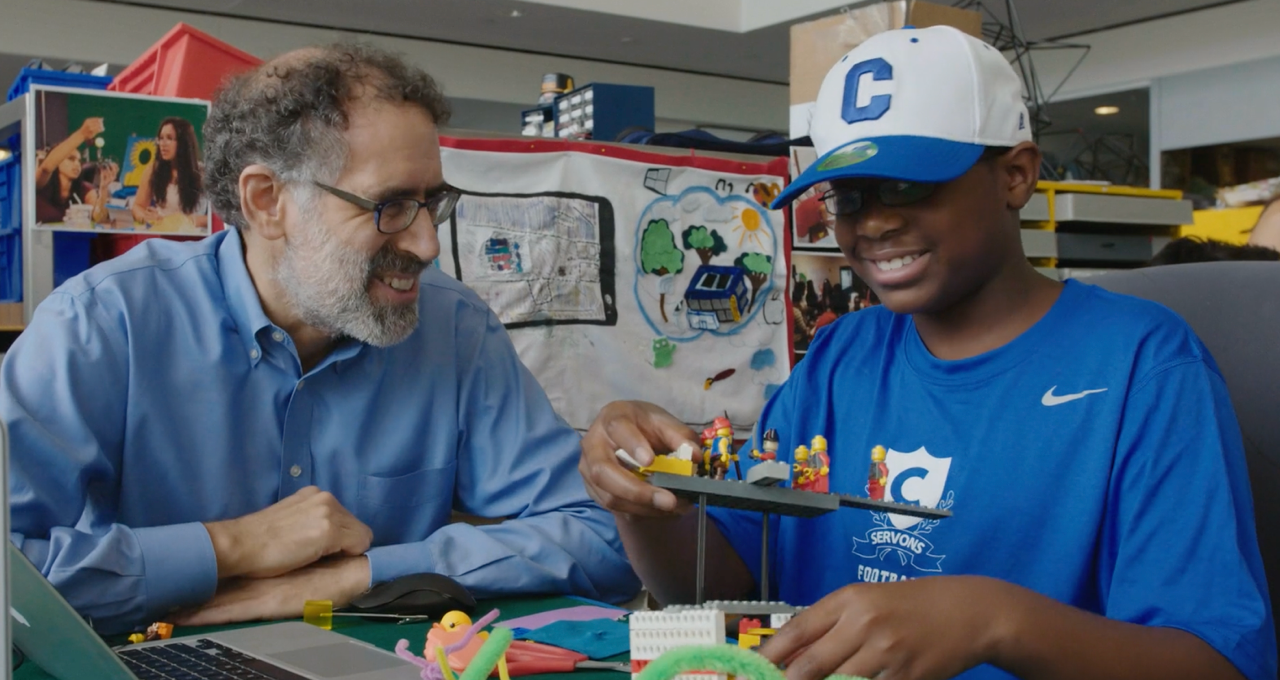 Man and child playing with Legos