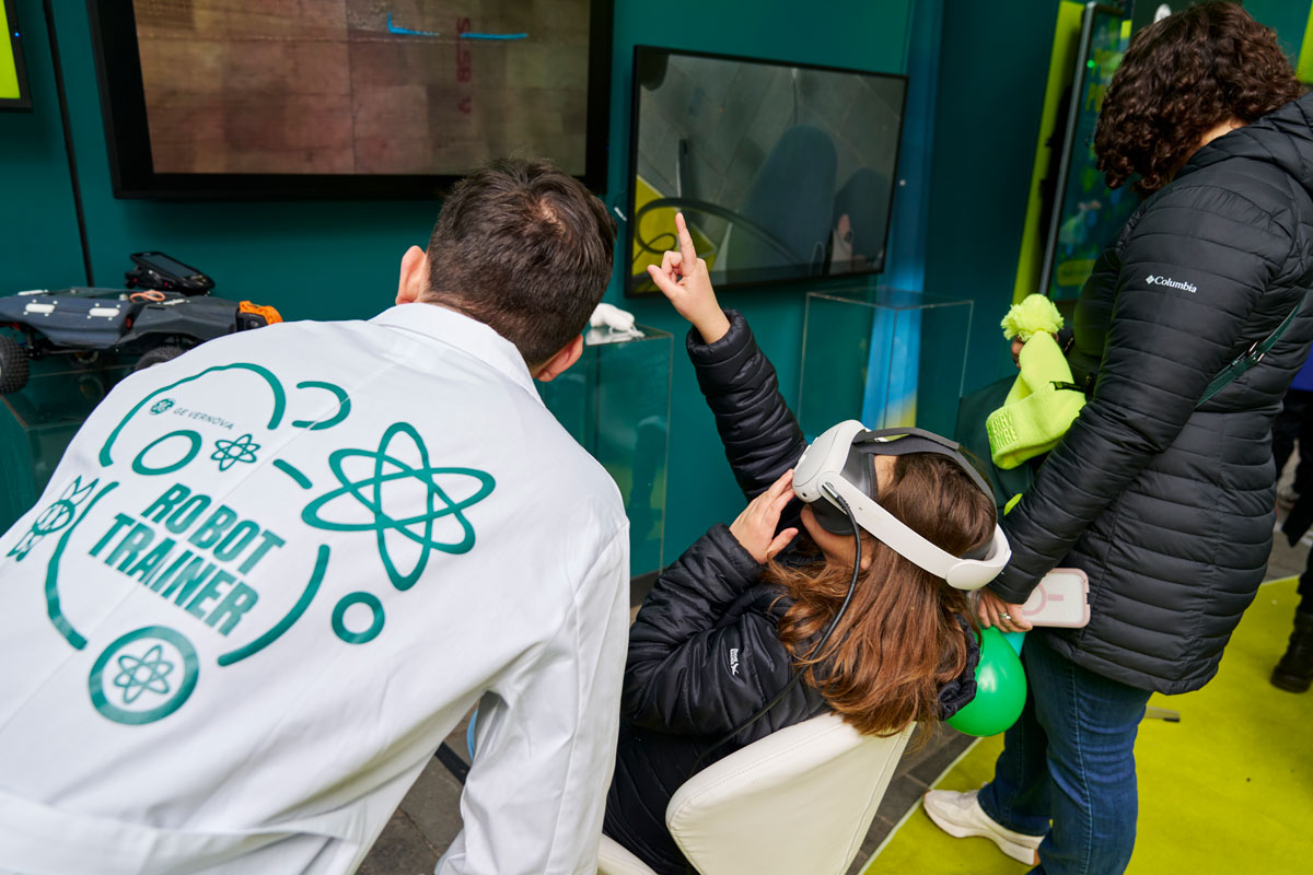 A girl wears a VR headset that pulls her into a digital wind turbine blade